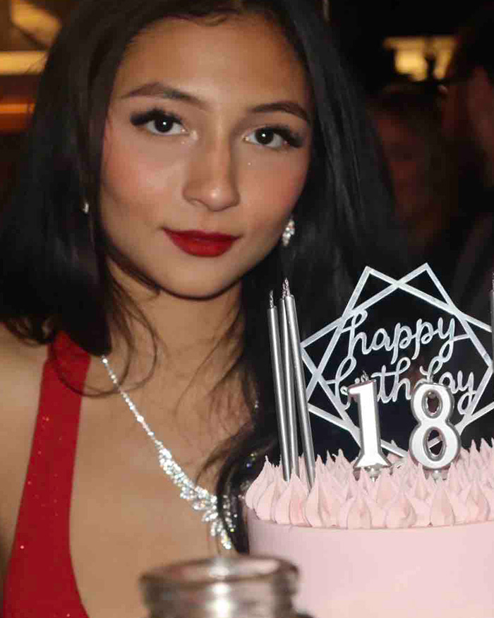 A young woman in a red dress with a Happy 18th Birthday cake, amidst a discussion of a disturbing relationship with daughter.