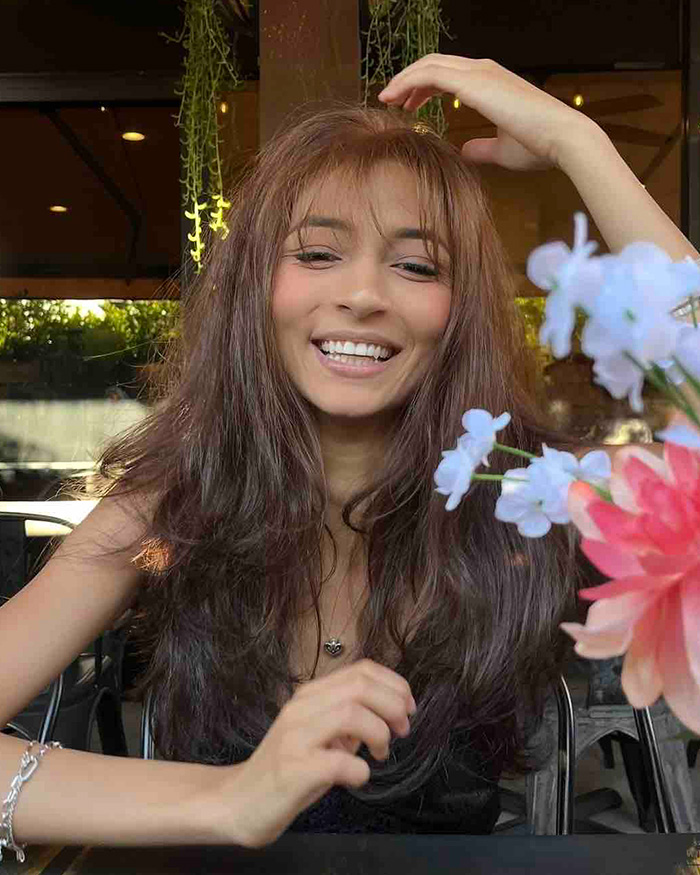 A young woman with long brown hair smiling, related to a story about a disturbing relationship with daughter.