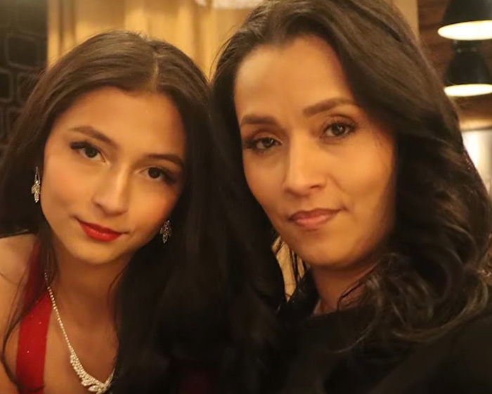 A woman and a young girl, possibly a daughter, looking at the camera, connected to a disturbing relationship story.