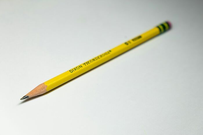 A yellow Dixon Ticonderoga pencil on a white background, representing a silly solution to real problems.