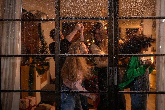 People dancing and enjoying themselves indoors during winter, reflecting human behavior in celebration.