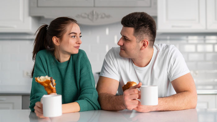 Image of couple eating breakfast and looking at each other Image of couple eating breakfast and looking at each other