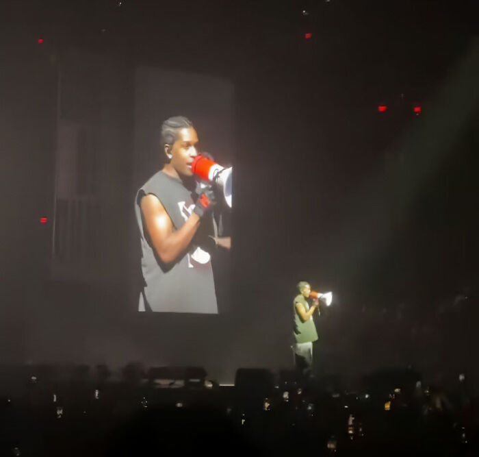 Rihanna's partner performs onstage with a megaphone, accused of disrespecting her with a racy comment.