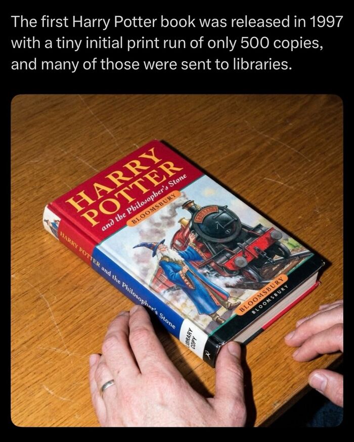 First Harry Potter book with limited print run held on a wooden table