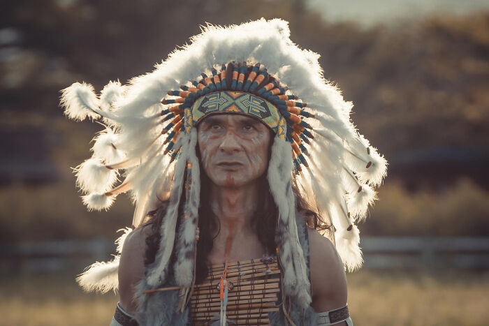 Native American man wearing traditional headdress