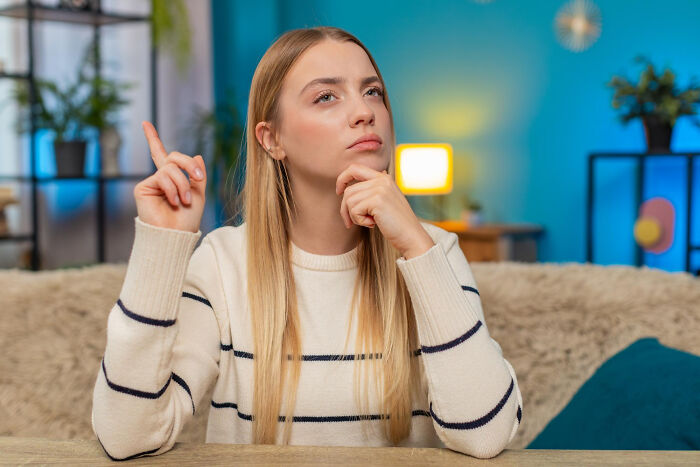 Woman deep in thought recalling random specific facts stored in her brain