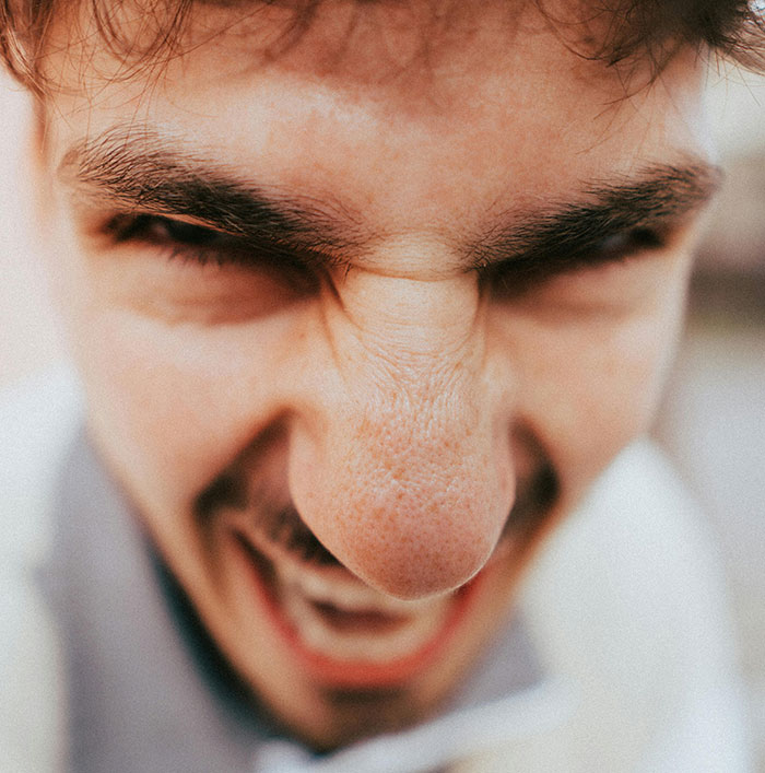 Close-up of angry man showing red flags
