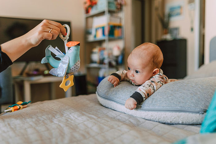 Baby focused on toy showing early red flags in family dynamics