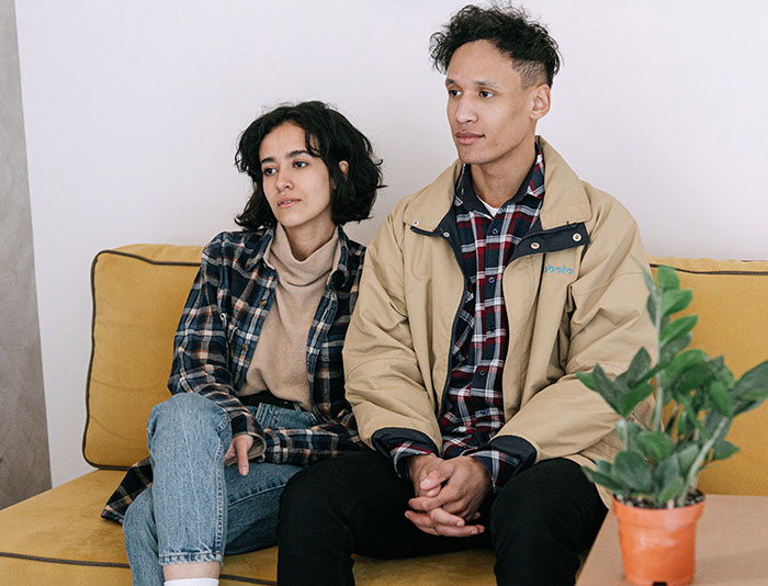 Couple sitting apart looking uneasy highlighting missed red flags