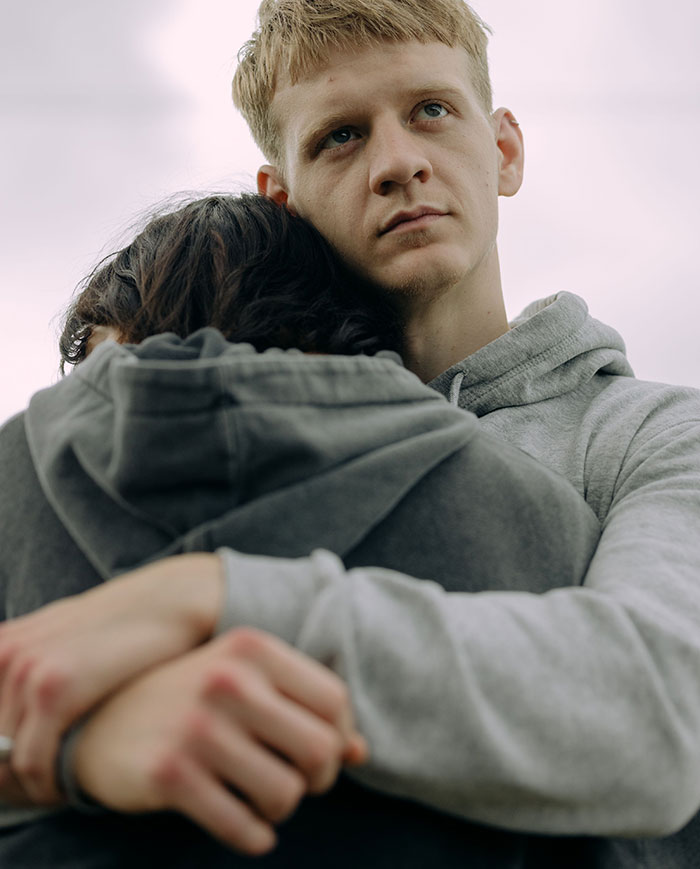 Couple embracing with man showing concern and red flags in relationship