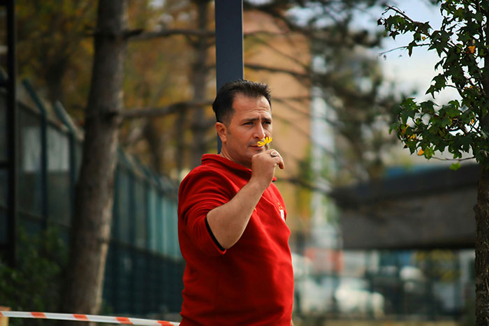 Man in red shirt smelling flower, reflecting on red flags missed after wedding