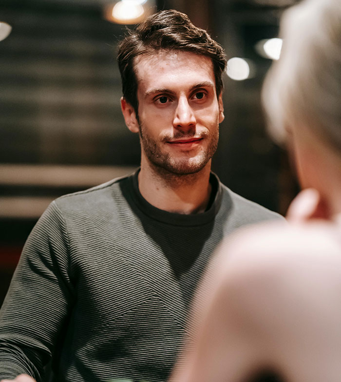Man giving a subtle smile hiding potential relationship red flags
