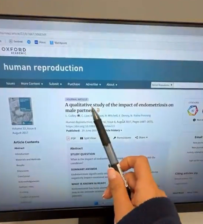 A doctor points to a study on a computer screen about the impact of endometriosis, focusing on infuriating studies.