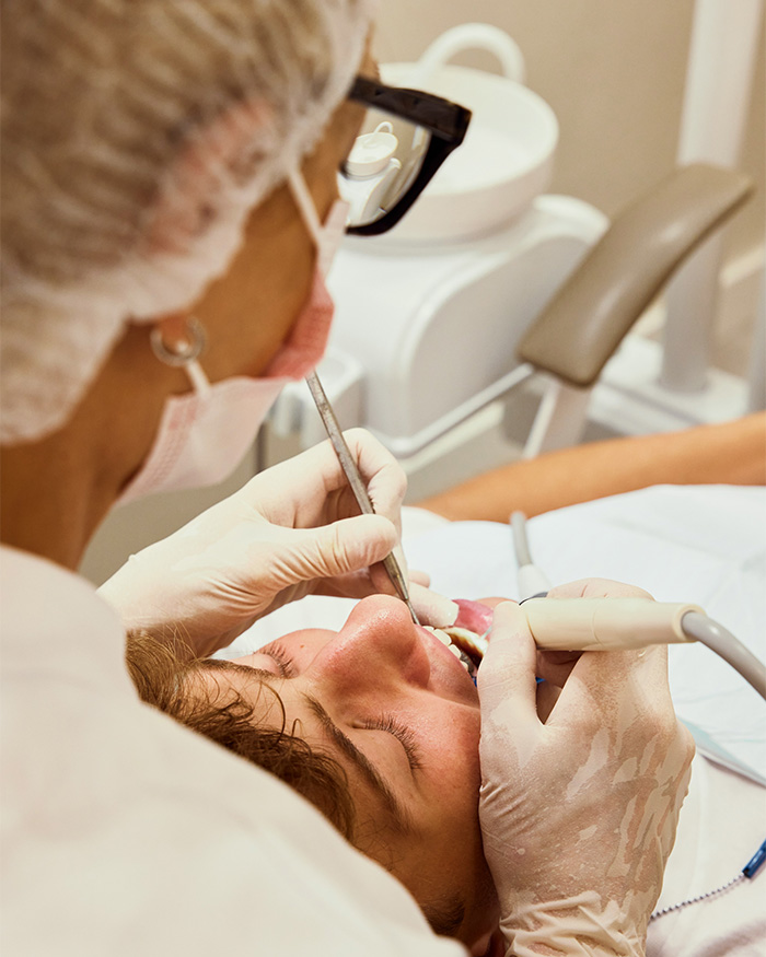 Dentist performing dental procedure on patient in clinic Dentist performing dental procedure on patient in clinic