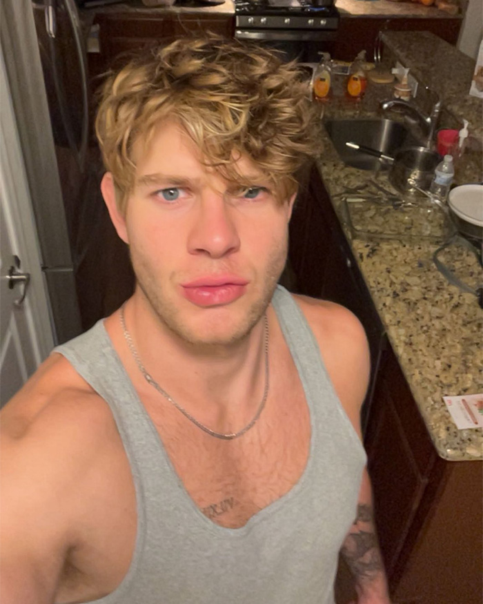 Man with tousled hair in tank top indoors selfies Man with tousled hair in tank top indoors selfies