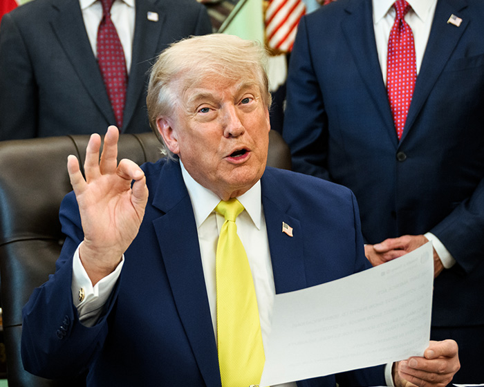 Donald Trump speaking and gesturing with a paper during the $14 million project backlash Donald Trump speaking and gesturing with a paper during the $14 million project backlash