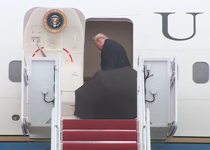 Donald Trump gaffes: President Trump exits Air Force One, shielding himself from rain with a black umbrella.