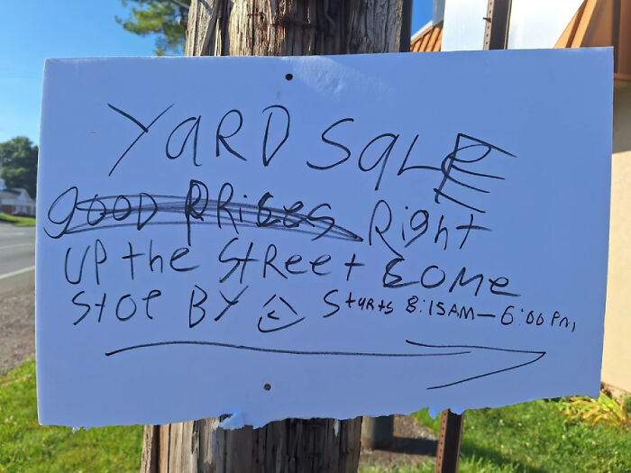 Funny neighbors notes: A handwritten yard sale sign on a pole with crossed-out text and an arrow pointing right.