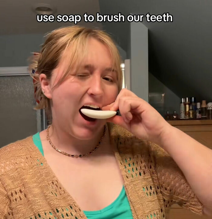 Woman demonstrating money-saving hack using soap to brush teeth Woman demonstrating money-saving hack using soap to brush teeth