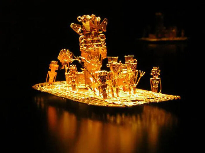 A golden ancient artifact depicting a group of figures on a raft, representing lost treasures.