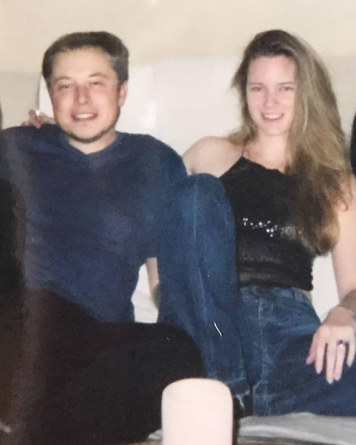 Elon Musk and a woman sitting together smiling in an indoor setting Elon Musk and a woman sitting together smiling in an indoor setting