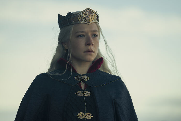 A Targaryen princess, part of the extensive House of the Dragon family tree, wearing a crown and regal attire. A Targaryen princess, part of the extensive House of the Dragon family tree, wearing a crown and regal attire.
