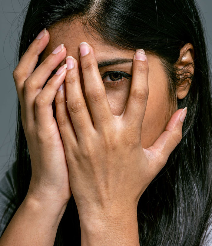 A woman covering her face, symbolizing the shame and consequence of a parenting fail that led to getting arrested. A woman covering her face, symbolizing the shame and consequence of a parenting fail that led to getting arrested.