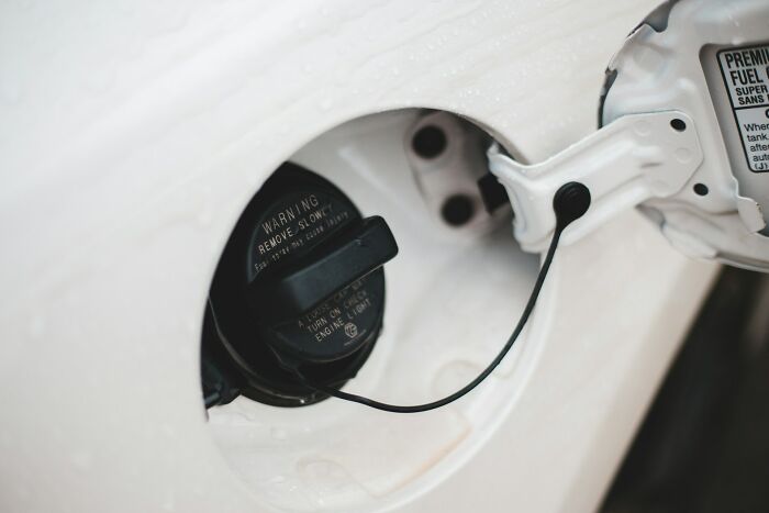 Car fuel cap open representing a satisfying action after finding out ex cheated