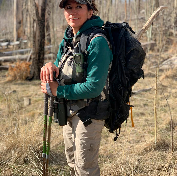 Scientist assistant hiking with backpack and gear in forest Scientist assistant hiking with backpack and gear in forest