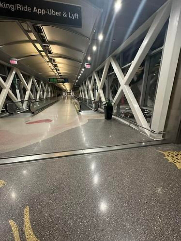 Long empty airport walkway with moving sidewalks, a haunting liminal space.
