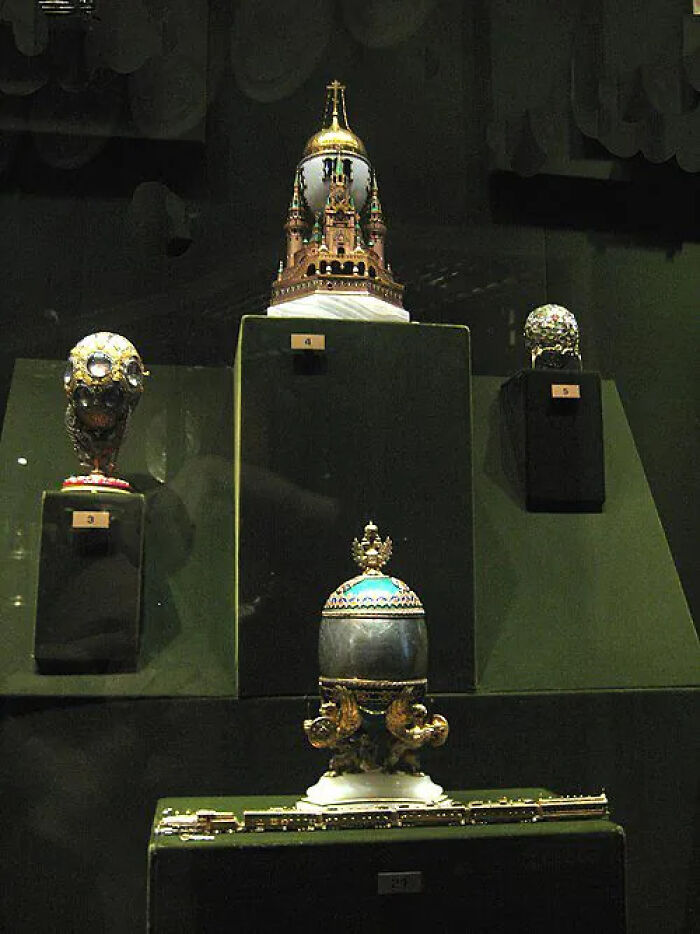 A display of four ornate lost treasures, featuring intricate gold and jeweled designs, from a history researcher's findings.
