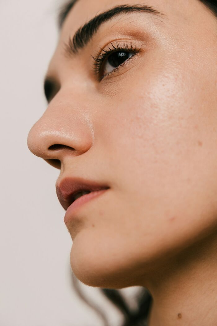 Detailed side view of a woman's face highlighting skin texture and features