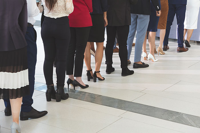 People standing politely in a line wearing business attire
