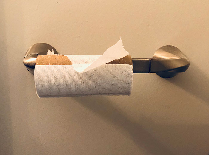 Empty toilet paper roll highlighting common courtesy unwritten rule