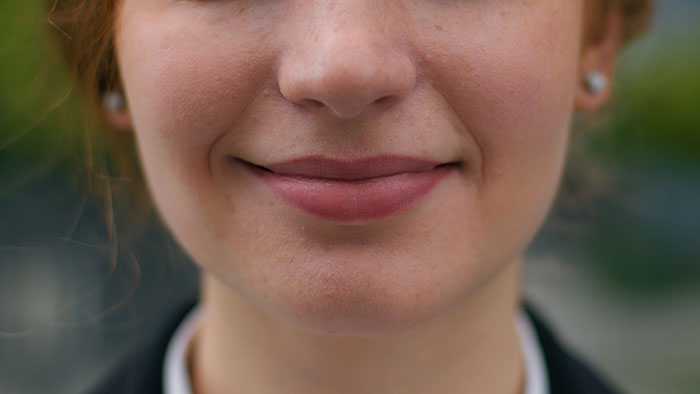 Close-up of a woman smiling with friendly unwritten rules