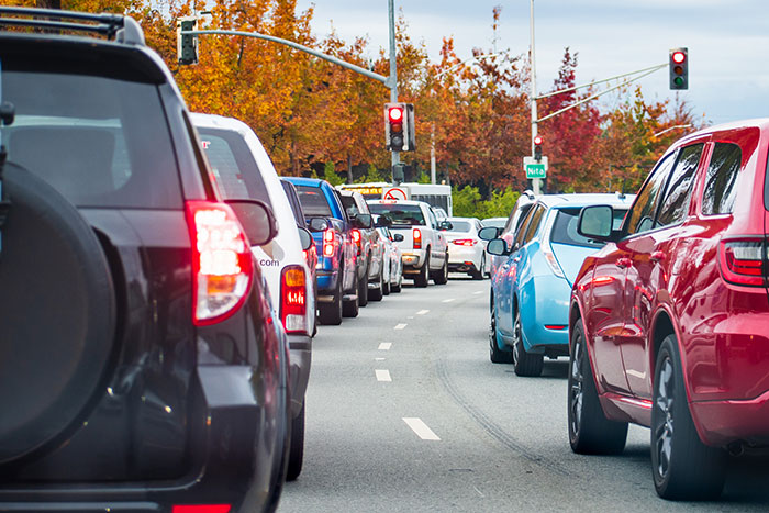 Cars lined up at a traffic light during rush hour traffic