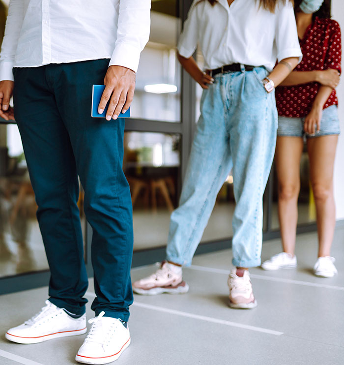 People standing in line practicing social distancing as an unwritten rule