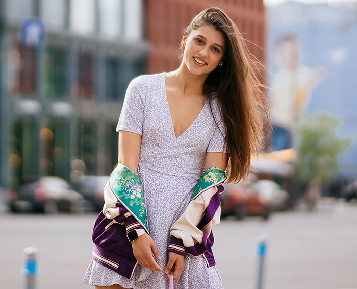 Young woman smiling outdoors showcasing unwritten rules of strangers