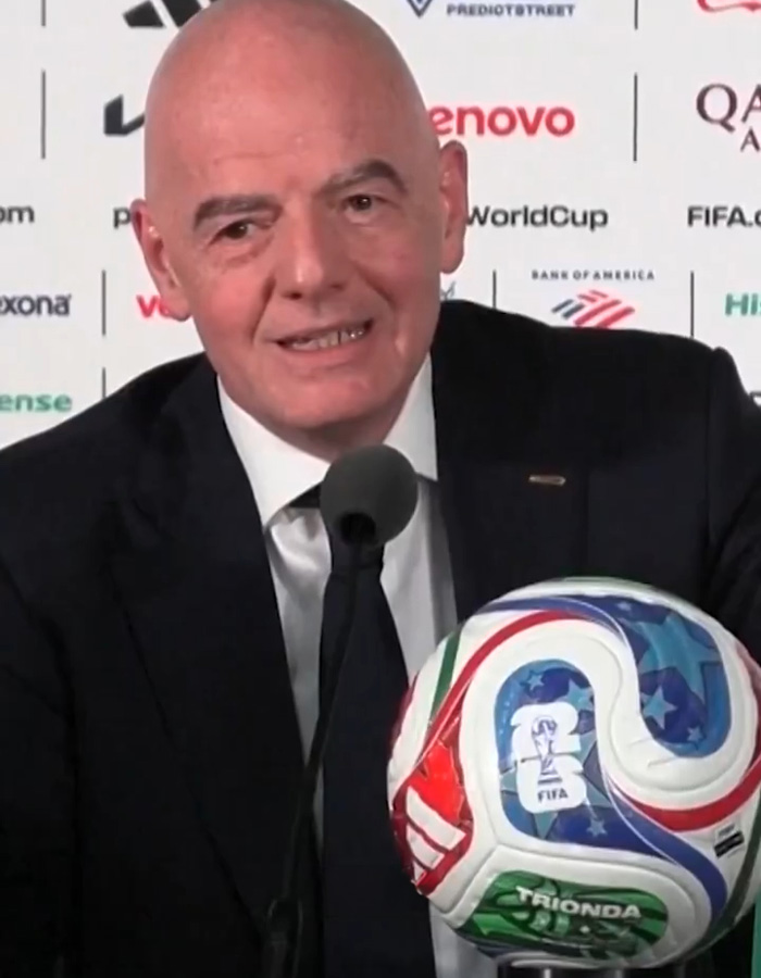 FIFA official speaking at press conference with World Cup soccer ball