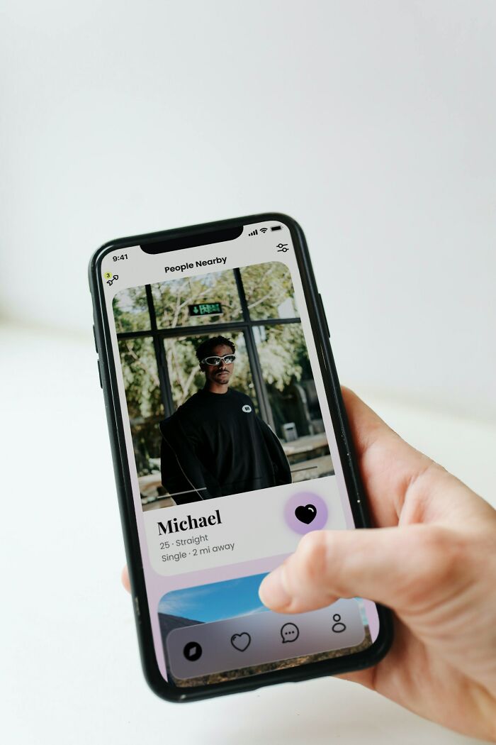 Person browsing dating app profile on phone for infidelity stories
