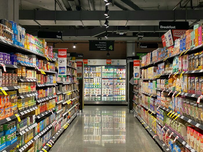 Grocery store aisle with breakfast cereals and tea products on shelves