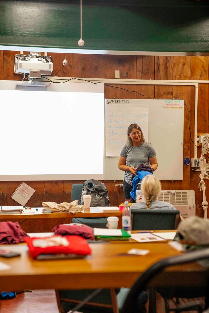Teacher addressing class with a presentation on facing consequences for class clown behavior