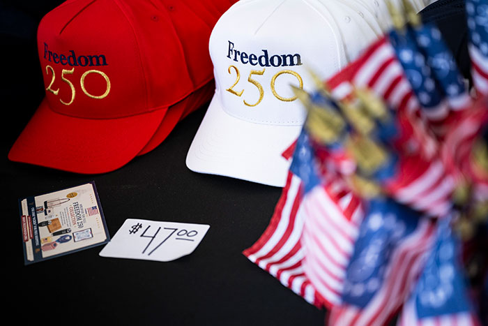 Freedom 250 hats and merchandise displayed with American flags