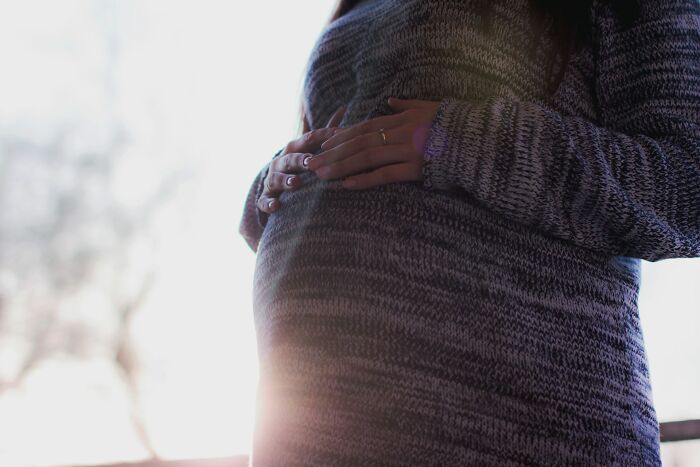 Pregnant woman holding belly showing pregnancy and motherhood