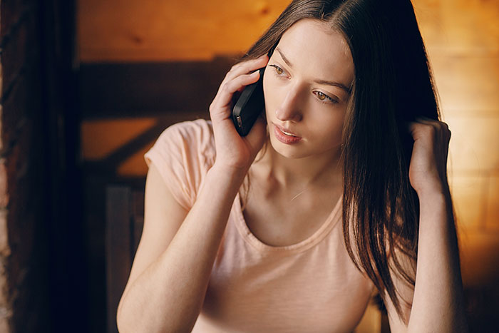 Woman discussing wedding plans on phone looking concerned Woman discussing wedding plans on phone looking concerned