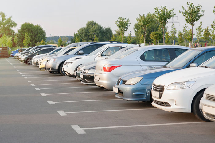 A line of cars parked in a lot, representing the potential for a car towed by a selfish friend. A line of cars parked in a lot, representing the potential for a car towed by a selfish friend.