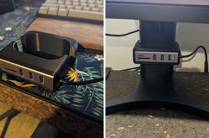 A custom 3D printed USB hub mount attached to a desk and under a monitor, improving everyday life.