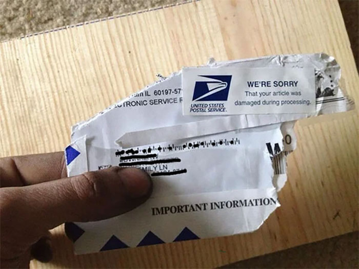 A damaged USPS package with a sticker indicating damage during processing, a common delivery fail that can make people cry.