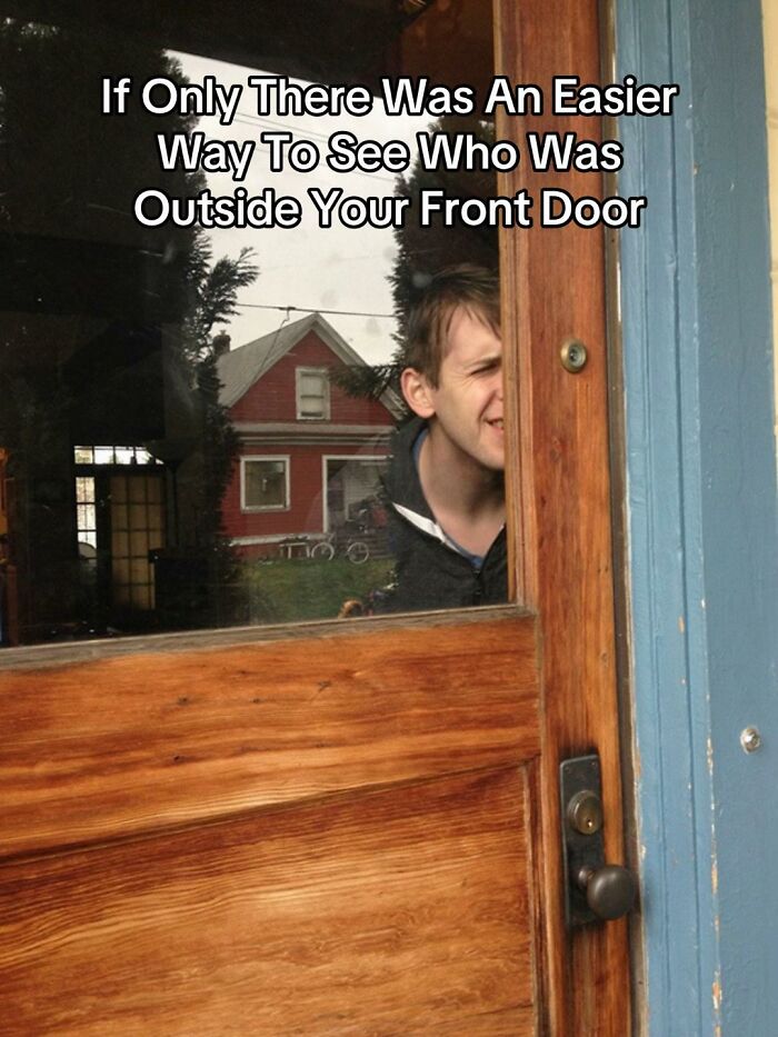 A man peeking through a wooden door, showing a funny bad design fail for not having a peephole.