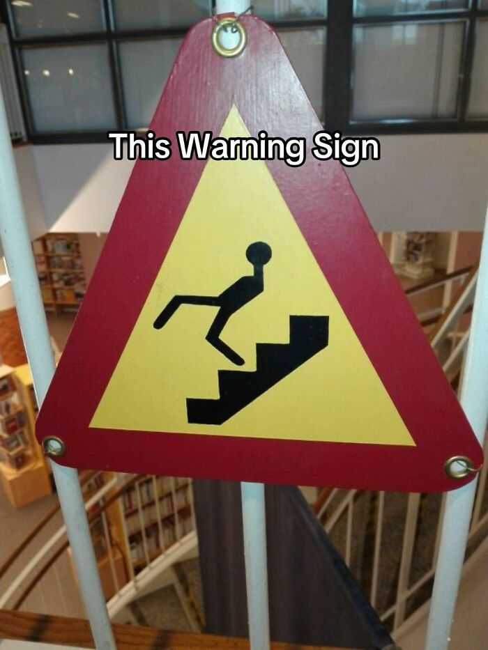 A triangular warning sign with a stick figure falling up stairs, a clear example of a bad design fail.